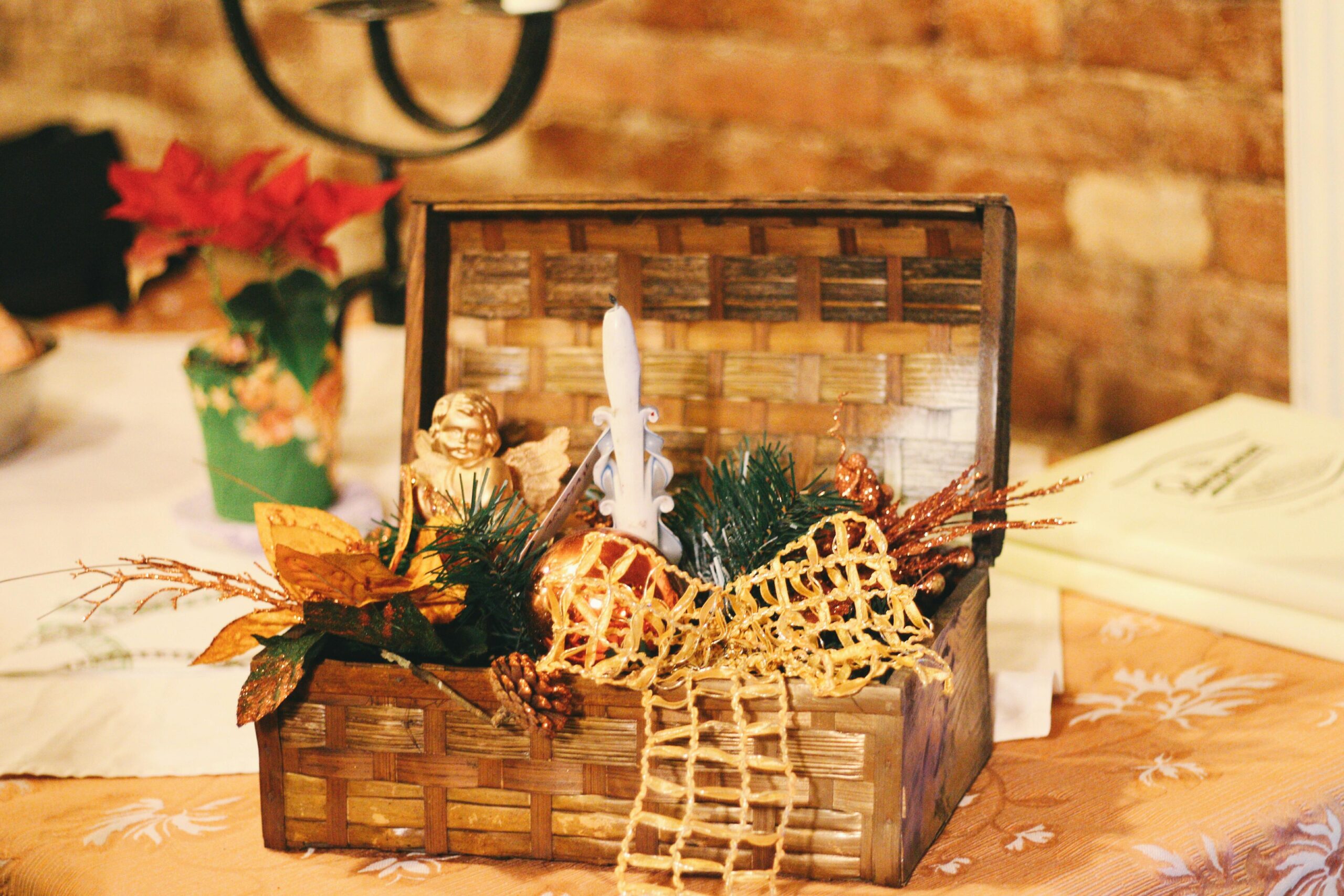 A simple wicker basket placed on a wooden table with gentle Christmas decor.