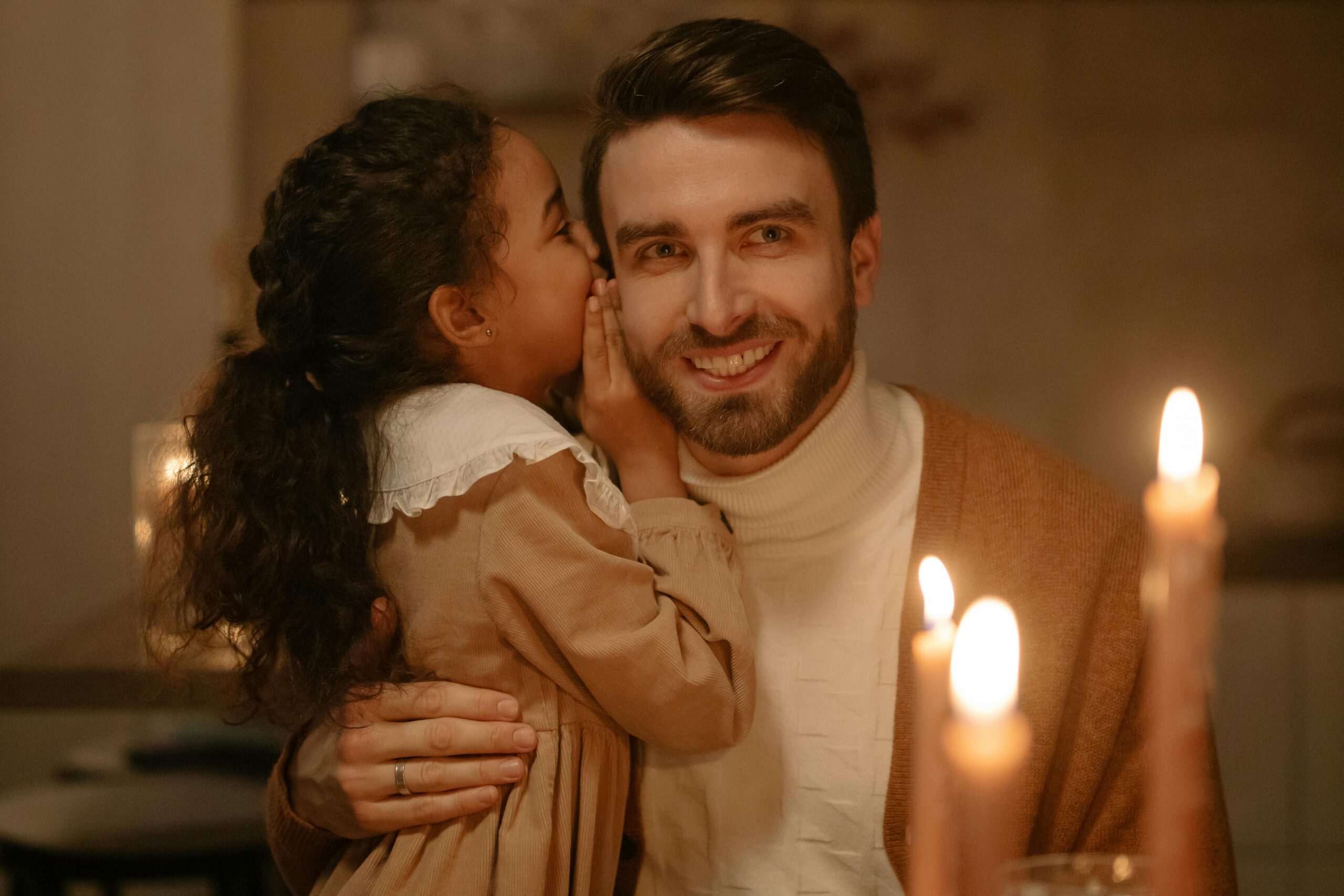 Parent and child lighting an Advent candle during Christmas devotion.”