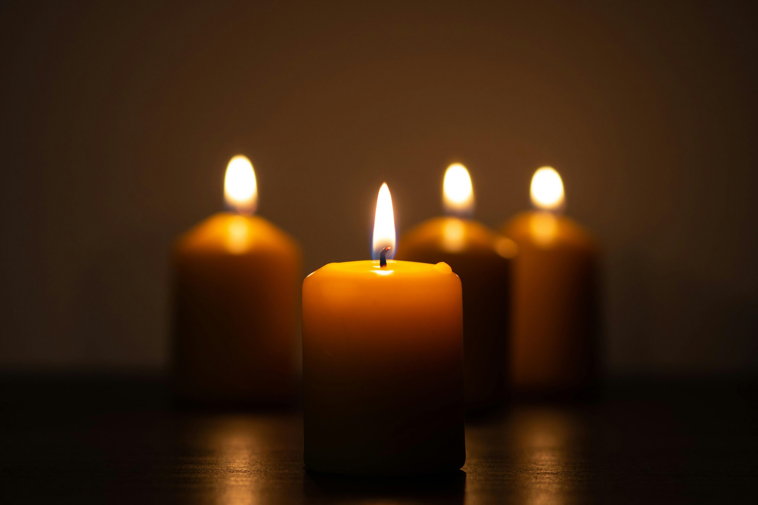 Lit advent candles creating a warm peaceful atmosphere in a home.
