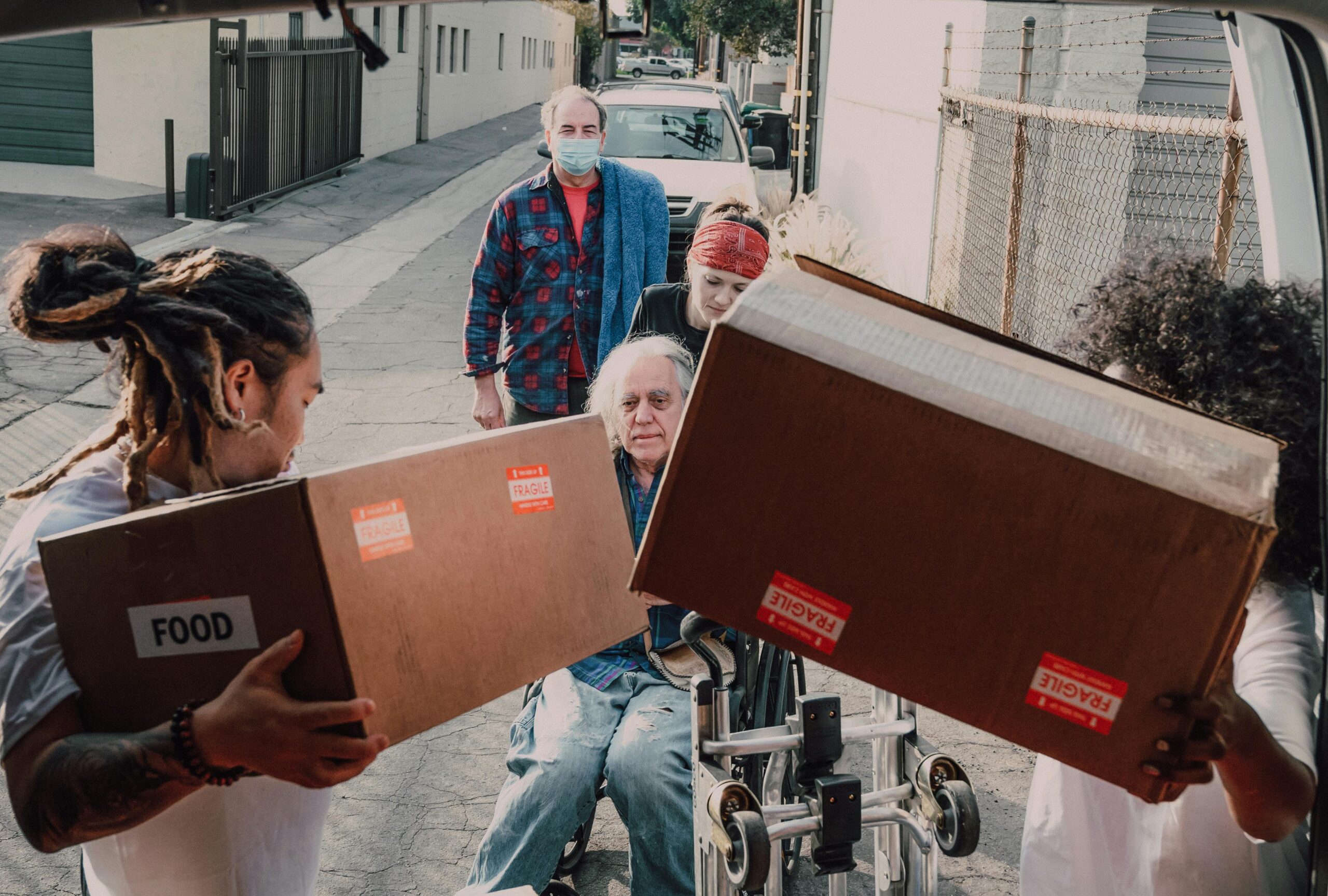 A family preparing a small bag of food to give to someone in need.