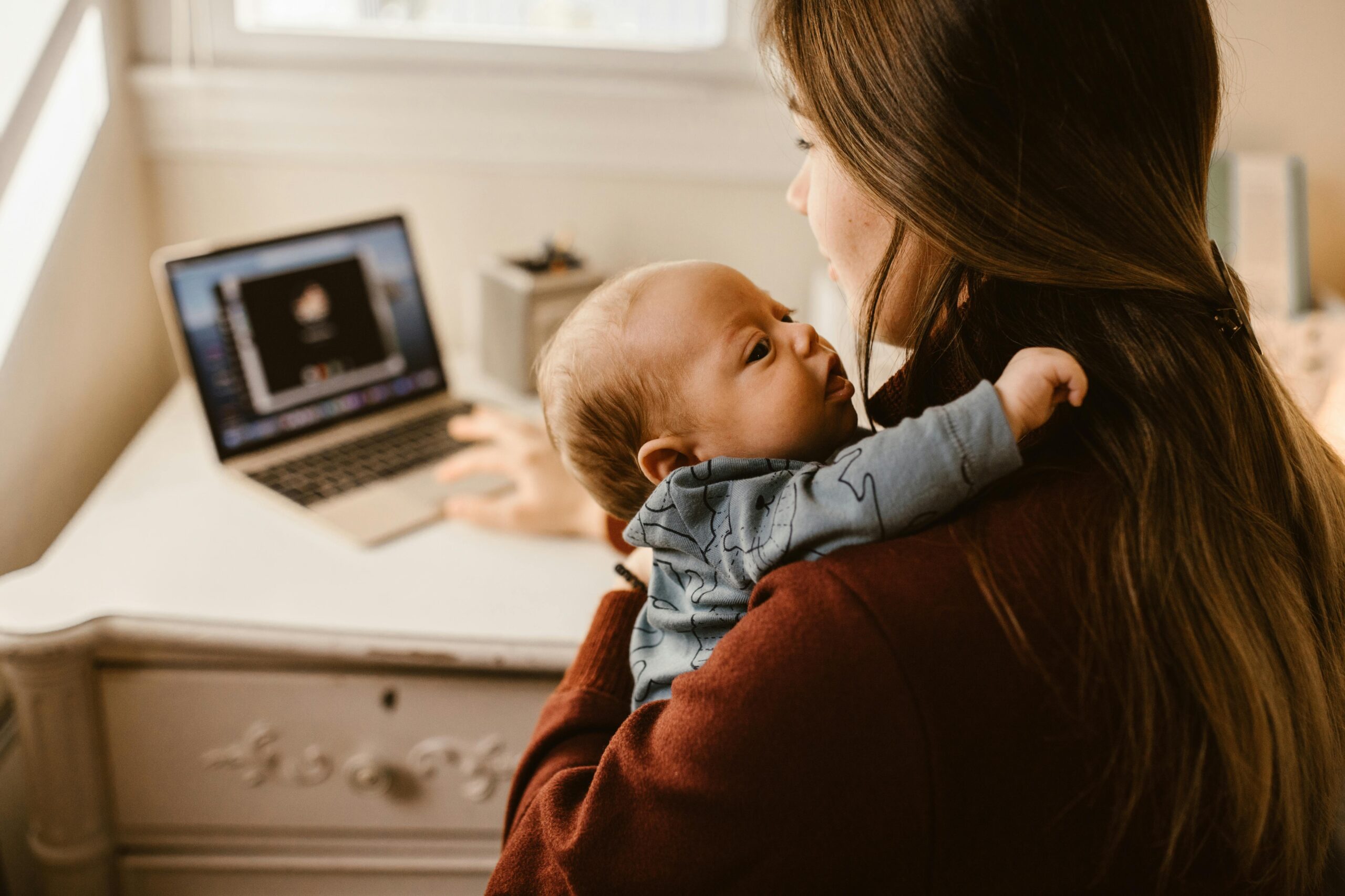 Mother holding her baby during an ordinary day at home